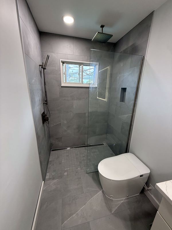 Curbless walk-in shower with large gray porcelain tile