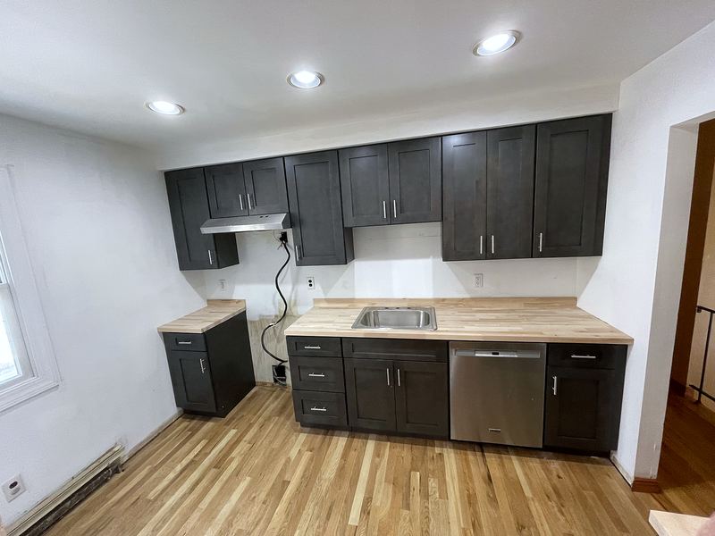 Charcoal cabinets with butcher block countertops