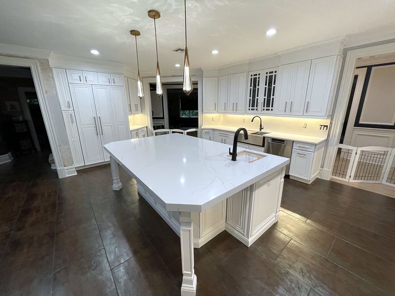 White kitchen island with seating and glass-front cabinets