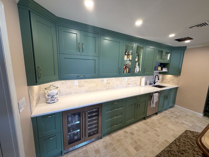 Green kitchen with wine fridges and tumbled stone backsplash