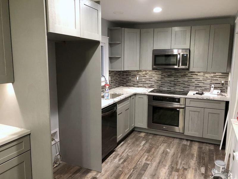 Gray shaker kitchen with glass mosaic backsplash